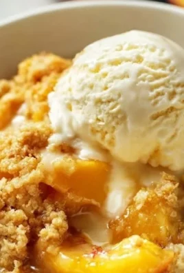 Delicious Peach Dump Cake fresh out of the oven, topped with golden brown crumble.