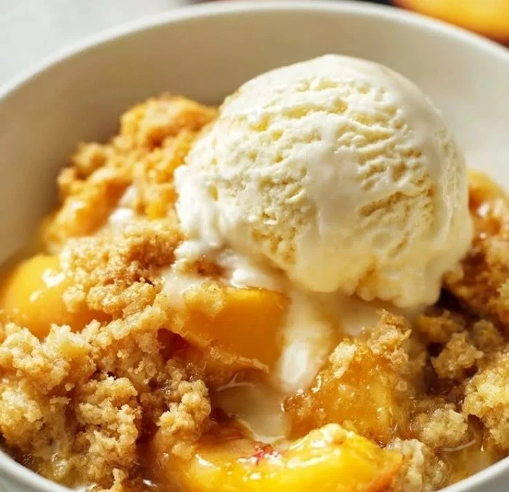 Delicious Peach Dump Cake fresh out of the oven, topped with golden brown crumble.