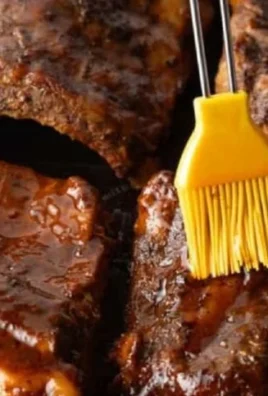 Delicious slow cooker ribs served with BBQ sauce on a plate
