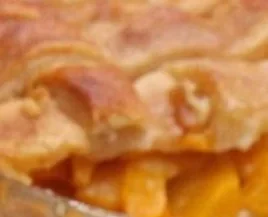 Delicious Southern peach cobbler served warm with ice cream