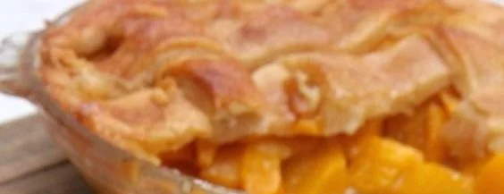 Delicious Southern peach cobbler served warm with ice cream