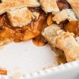 Southern peach cobbler dessert with pie crust and fresh peaches