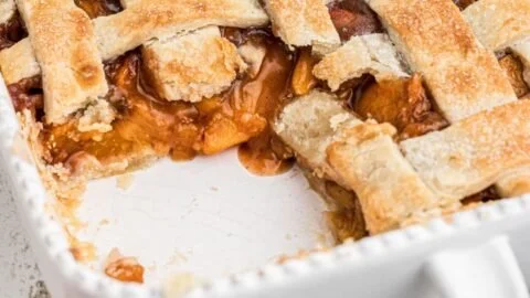 Southern peach cobbler dessert with pie crust and fresh peaches
