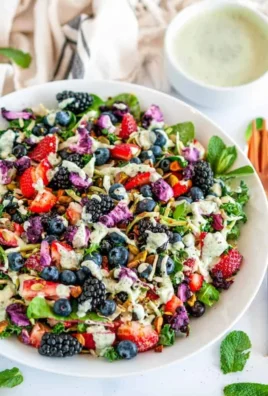 Superfood berry salad topped with creamy lemon herb dressing
