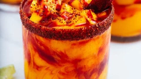 Delicious homemade mangonada topped with fresh mango and chili