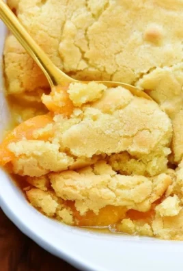 Delicious peach cobbler with a golden crust and fresh peaches.
