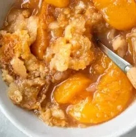 Delicious Southern peach cobbler served in a baking dish