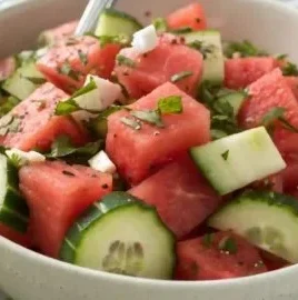 Fresh watermelon cucumber salad with mint and lime in a bowl