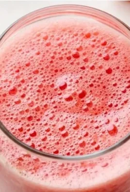 Freshly made watermelon juice in a glass with mint leaves