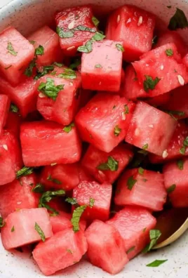 Vibrant watermelon mint salad served in a bowl with fresh mint leaves.