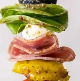 Colorful antipasto skewers with olives, cheese, and salami on a platter