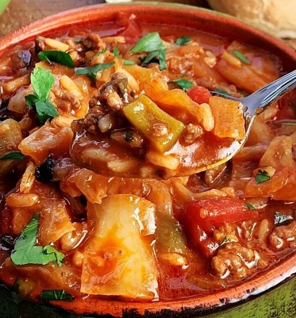 Bowl of cabbage soup with ground beef and vegetables