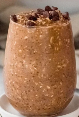 Bowl of chocolate overnight oats topped with fruits and nuts