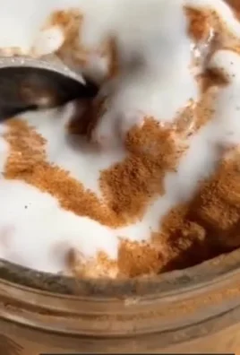 Bowl of cinnamon roll overnight oats topped with spices and nuts