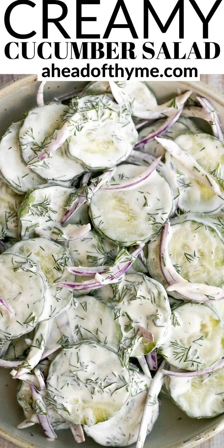 Creamy cucumber salad served in a bowl with fresh cucumbers and herbs