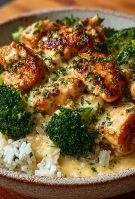 Creamy garlic chicken rice bowls served in a bowl with fresh vegetables