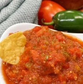 Ingredients and jars of easy homemade salsa for canning recipe