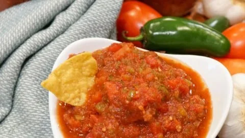 Ingredients and jars of easy homemade salsa for canning recipe