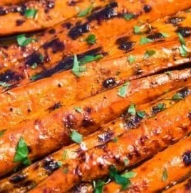Grilled and glazed carrots recipe showcasing vibrant, charred vegetables on a plate.