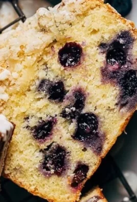 Freshly baked Lemon Blueberry Loaf with vibrant blueberries and zesty lemon glaze
