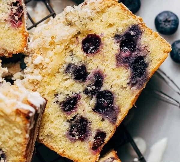 Freshly baked Lemon Blueberry Loaf with vibrant blueberries and zesty lemon glaze