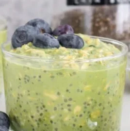 Bowl of matcha overnight oats topped with fruits and nuts