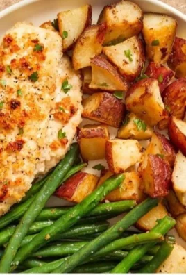 Parmesan Crusted Chicken on a sheet pan with colorful vegetables