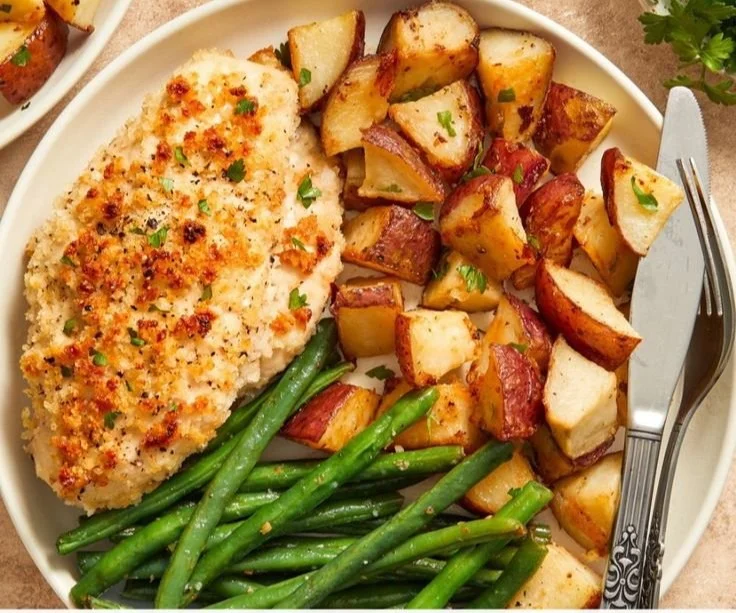 Parmesan Crusted Chicken on a sheet pan with colorful vegetables