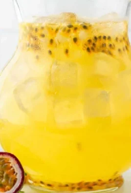 Refreshing glass of passion fruit lemonade with mint and fruit garnish