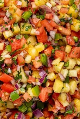 Delicious homemade pineapple salsa served in a bowl with fresh ingredients.