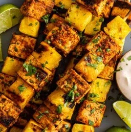 Grilled Pineapple Tofu Skewers with colorful vegetables on a plate