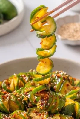Bowl of spicy Asian cucumber salad with vibrant vegetables and herbs