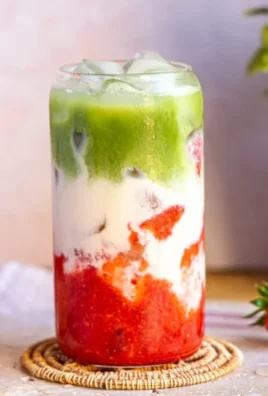 Strawberry Matcha Latte topped with fresh strawberries and matcha powder