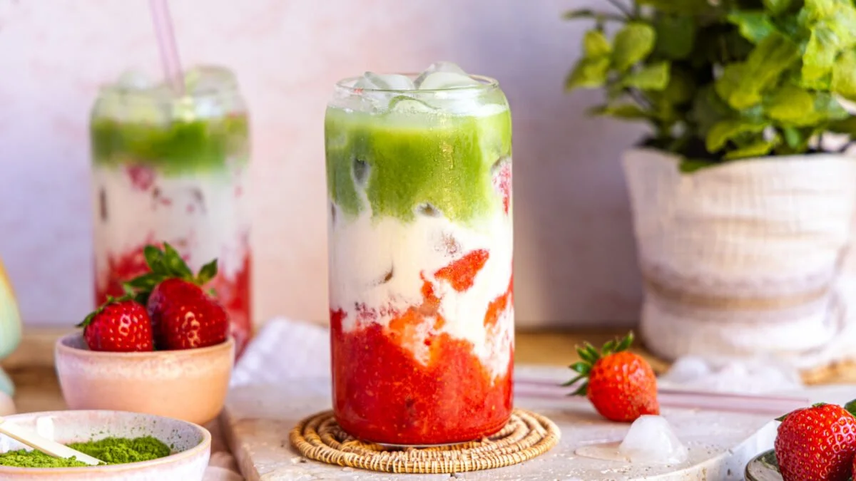 Strawberry Matcha Latte topped with fresh strawberries and matcha powder